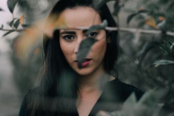 selective focus photography of woman beside grass