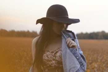 Selective Focus Photography of Woman Biting Her Denim Jacket