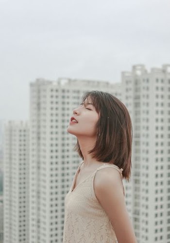 selective focus photography of woman closing her eyes