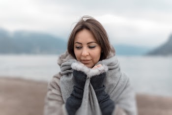 Selective Focus Photography of Woman Embracing Grey Blanket