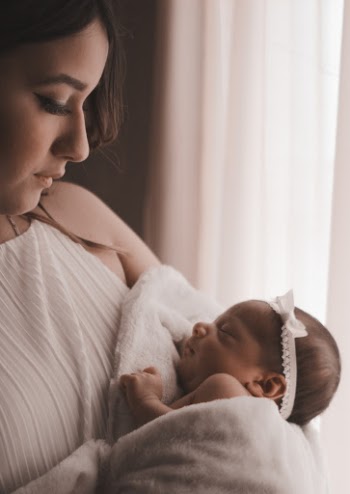 Selective Focus Photography of Woman Holding Baby