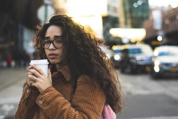 Selective Focus Photography of Woman Holding Disposable Cup