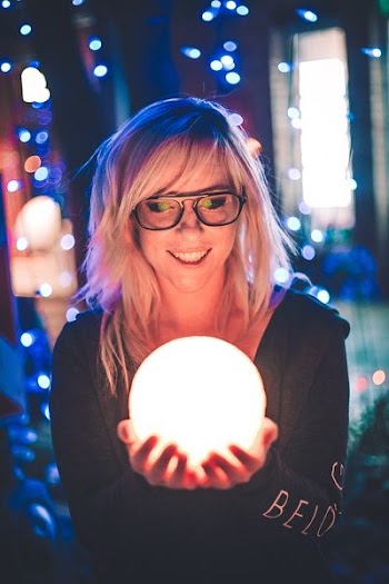selective focus photography of woman holding lighted ball