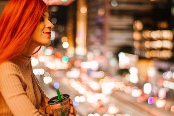 Selective Focus Photography Of Woman Holding Plastic Cup