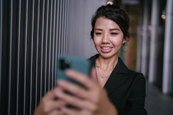Selective Focus Photography of Woman Holding Smartphone