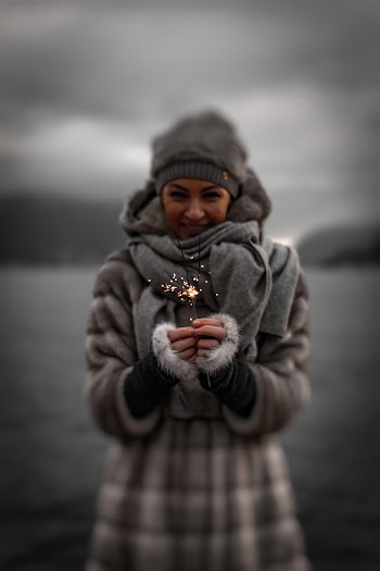 Selective Focus Photography of Woman Holding Sprinkler