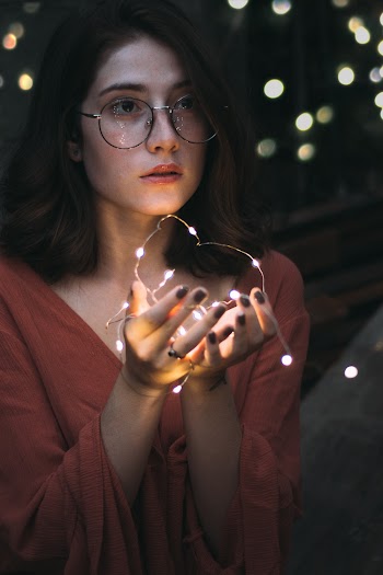 Selective Focus Photography of Woman Holding String Lights
