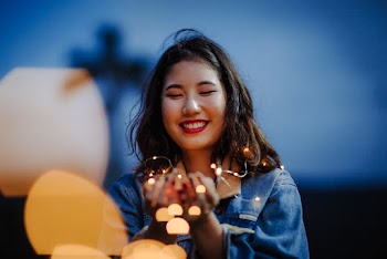 Selective Focus Photography Of Woman Holding String Lights