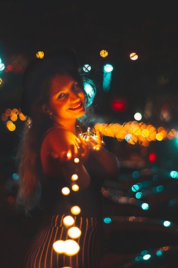 Selective Focus Photography Of Woman Holding String Lights