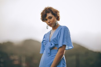 Selective Focus Photography Of Woman In Blue Crop Top Standing