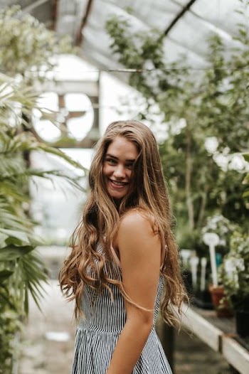 selective focus photography of woman in pinstripe dress