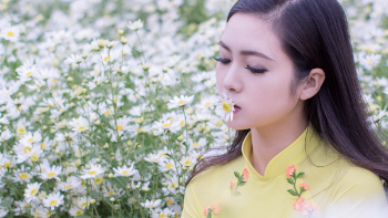 Selective Focus Photography of Woman Kissing White Petaled Flower
