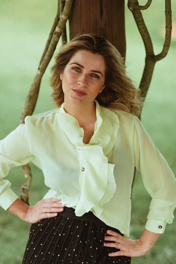 Selective Focus Photography of Woman Leaning on Pole