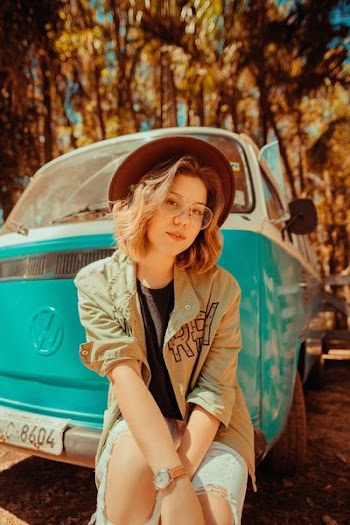selective focus photography of woman leaning on Volkswagen T2 van