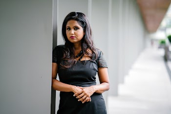 Selective Focus Photography of Woman Leaning on White Concrete Wall