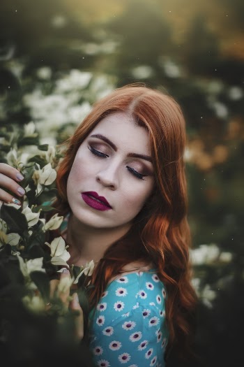Selective Focus Photography of Woman Near Flowers