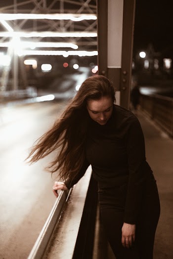 Selective Focus Photography of Woman on Bridge
