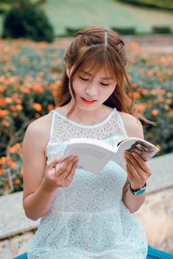 Selective Focus Photography Of Woman Reading A Book