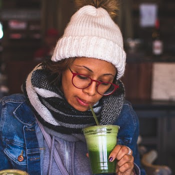 Selective Focus Photography of Woman Sipping from Disposable Cup