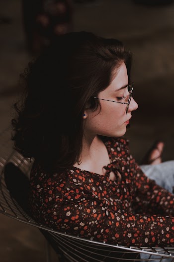 Selective Focus Photography of Woman Sitting on Chair