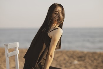 Selective Focus Photography of Woman Sitting on Chair