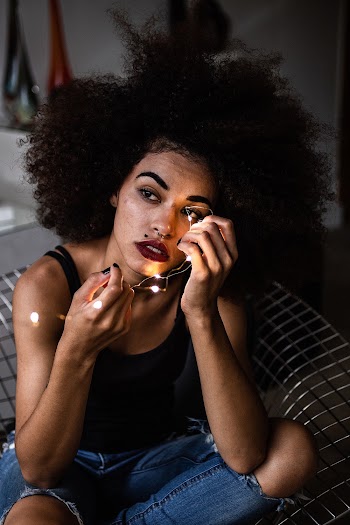 Selective Focus Photography of Woman Sitting on Chair