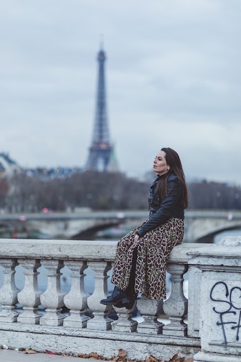 Selective Focus Photography Of Woman Sitting On Concrete Baluster