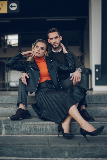 Selective Focus Photography of Woman Sitting on Concrete Stair Leaning on Man