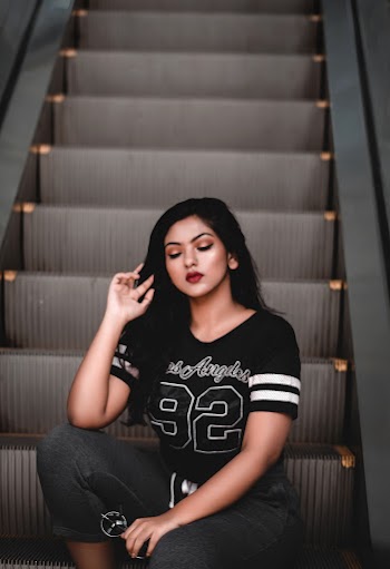 Selective Focus Photography Of Woman Sitting On Escalator