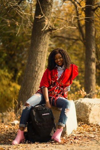Selective Focus Photography of Woman Sitting on Gray Concrete Block