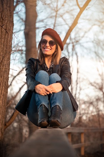 Selective Focus Photography of Woman Sitting on Rail