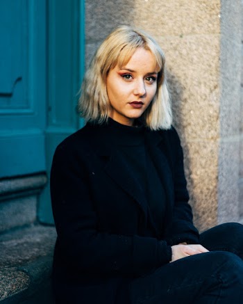 Selective Focus Photography Of Woman Sitting On Stairs In Front Of Door