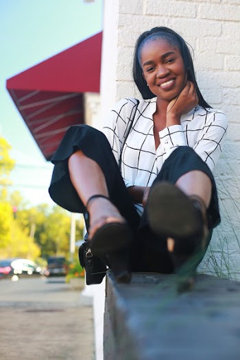 Selective Focus Photography of Woman Sitting While Smiling