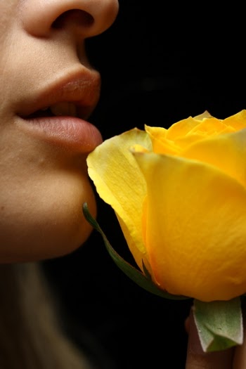 Selective Focus Photography of Woman Smelling Yellow Rose Flower