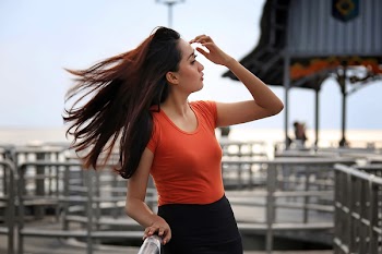 Selective Focus Photography of Woman Standing Near Railing