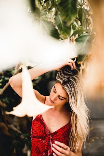 selective focus photography of woman under tree