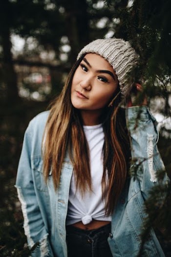 selective focus photography of woman wearing beanie and blue denim jacket