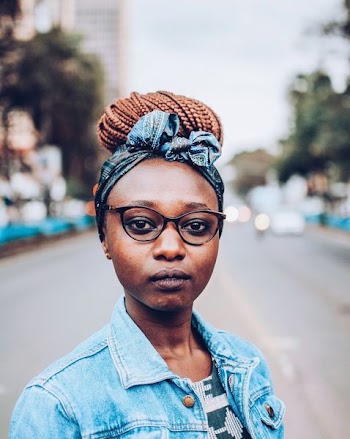 Selective Focus Photography of Woman Wearing Blue and Multicolored Headband and Blue Denim Jacket