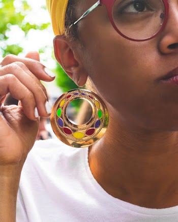 Selective Focus Photography of Woman Wearing Gold-colored Hoop Earring