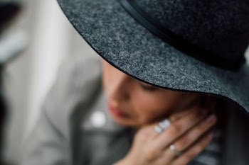 selective focus photography of woman wearing gray hat