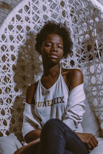 Selective Focus Photography of Woman Wearing Halter Shirt Sitting on Chair