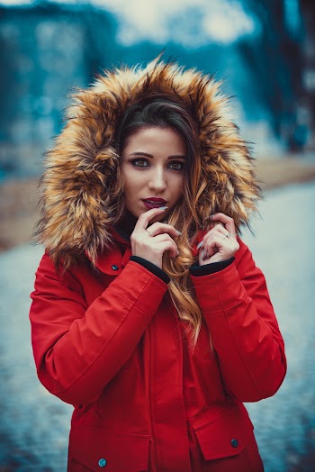 Selective Focus Photography of Woman Wearing Red and Brown Parka Coat