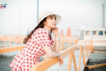 Selective Focus Photography of Woman Wearing Red-and-white Puff-sleeved Dress at Docks