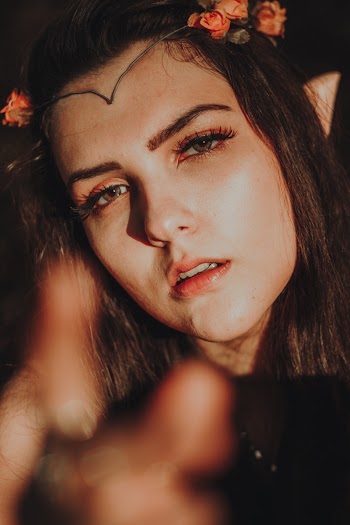Selective Focus Photography of Woman Wearing Red Floral Headdress