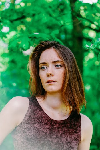 Selective Focus Photography of Woman Wearing Tank Top
