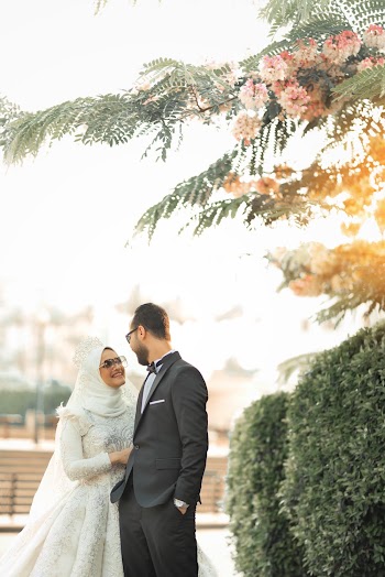 Selective Focus Photography of Woman Wearing White Abaya Wedding Dress Smiling in Front of Man in Black Tuxedo