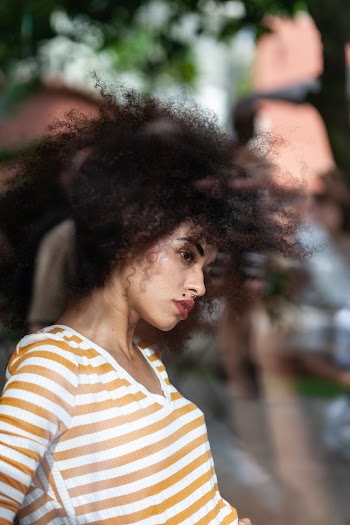 Selective Focus Photography of Woman Wearing White-and-brown Striped V-neck Shirt