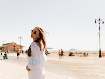 Selective Focus Photography of Woman Wearing White Long-sleeved Top