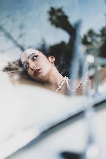 Selective Focus Photography Of Woman Wearing White Pearl Necklace