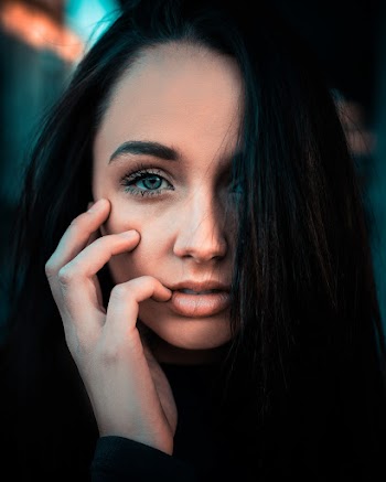 Selective Focus Photography of Woman With Right Hand on Face